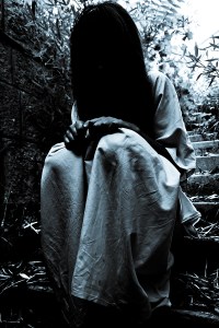 We See a Motionless Girl with Hair Over Her Face